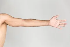 An extended human arm and open hand against a plain background