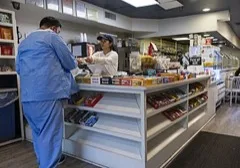 A customer paying a cashier at a shop counter