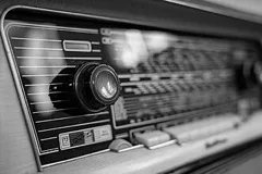 A close-up of a vintage radio dial and knobs