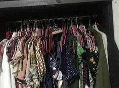 Rows of clothes hanging inside a closet