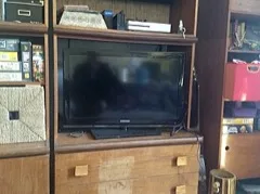 A flat-screen television in a wooden cabinet