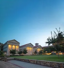 A university campus building illuminated at dusk